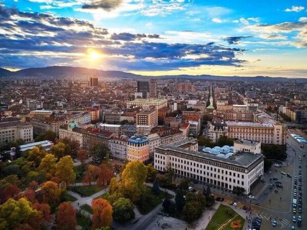Rent an apartment in Sofia 10 Aerial view of Sofia under a morning sunrise.
