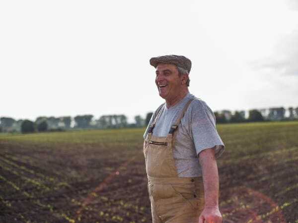A happy farmer after having acquired an agricultural land for sale in Bulgaria.