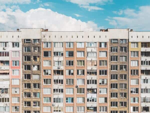 Front view of a Bulgarian building with properties to buy and rent.