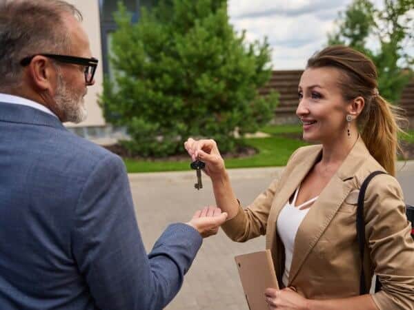 Property for Sale in Bulgaria 19 A real estate broker is giving key to a buyer of a property for sale in Bulgaria.