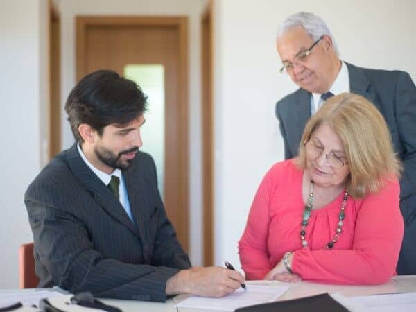 Property for Sale in Bulgaria 21 A couple of investors sign a buying document with a real estate agent broker about a Bulgarian property for sale.