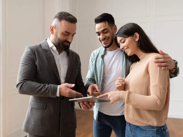 An happy couple and a real estate agent in a property to rent in a Bulgaria.