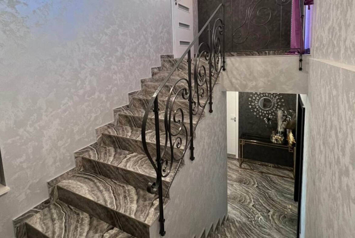 Marble stairs with forged iron railing