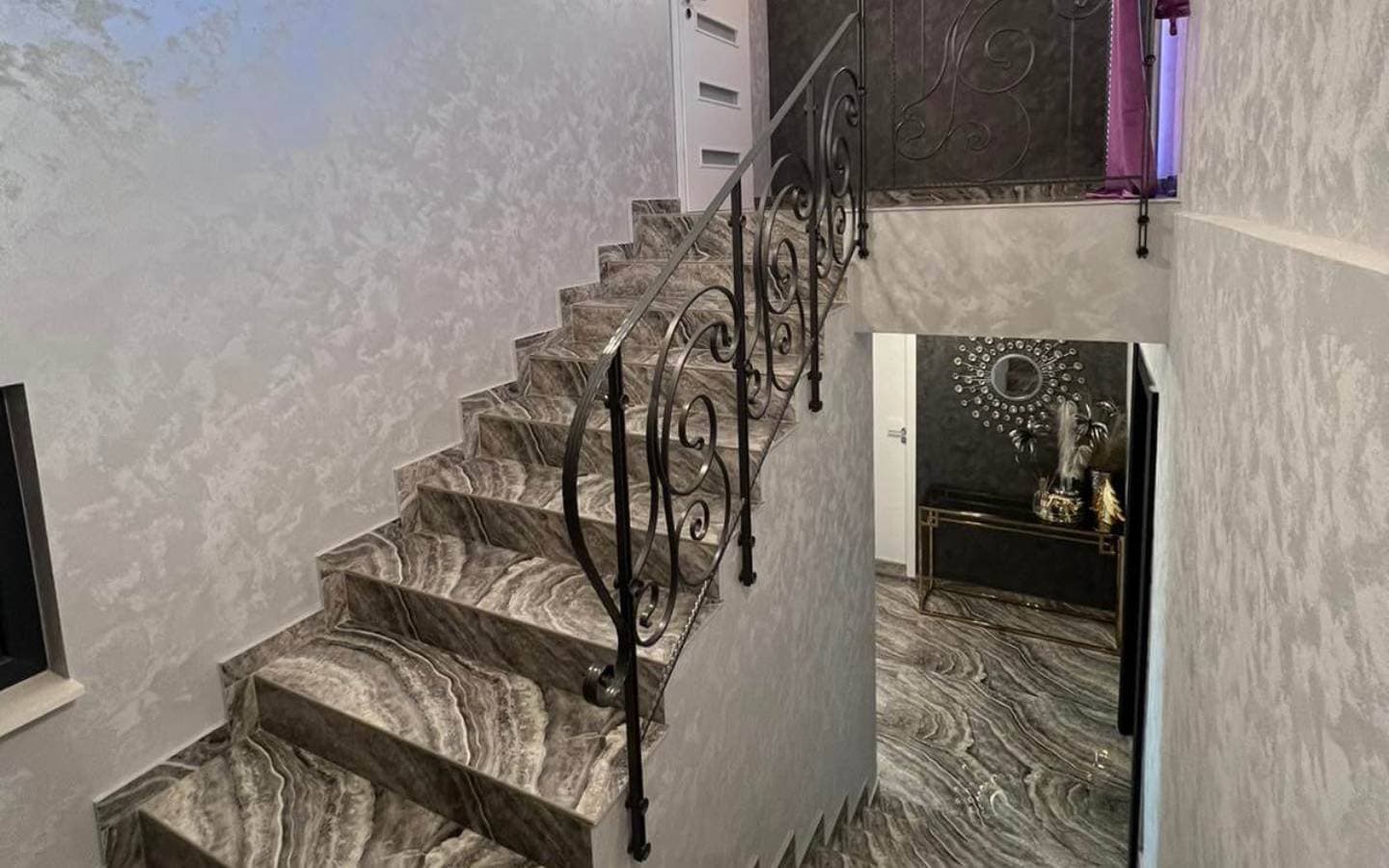 Marble stairs with forged iron railing