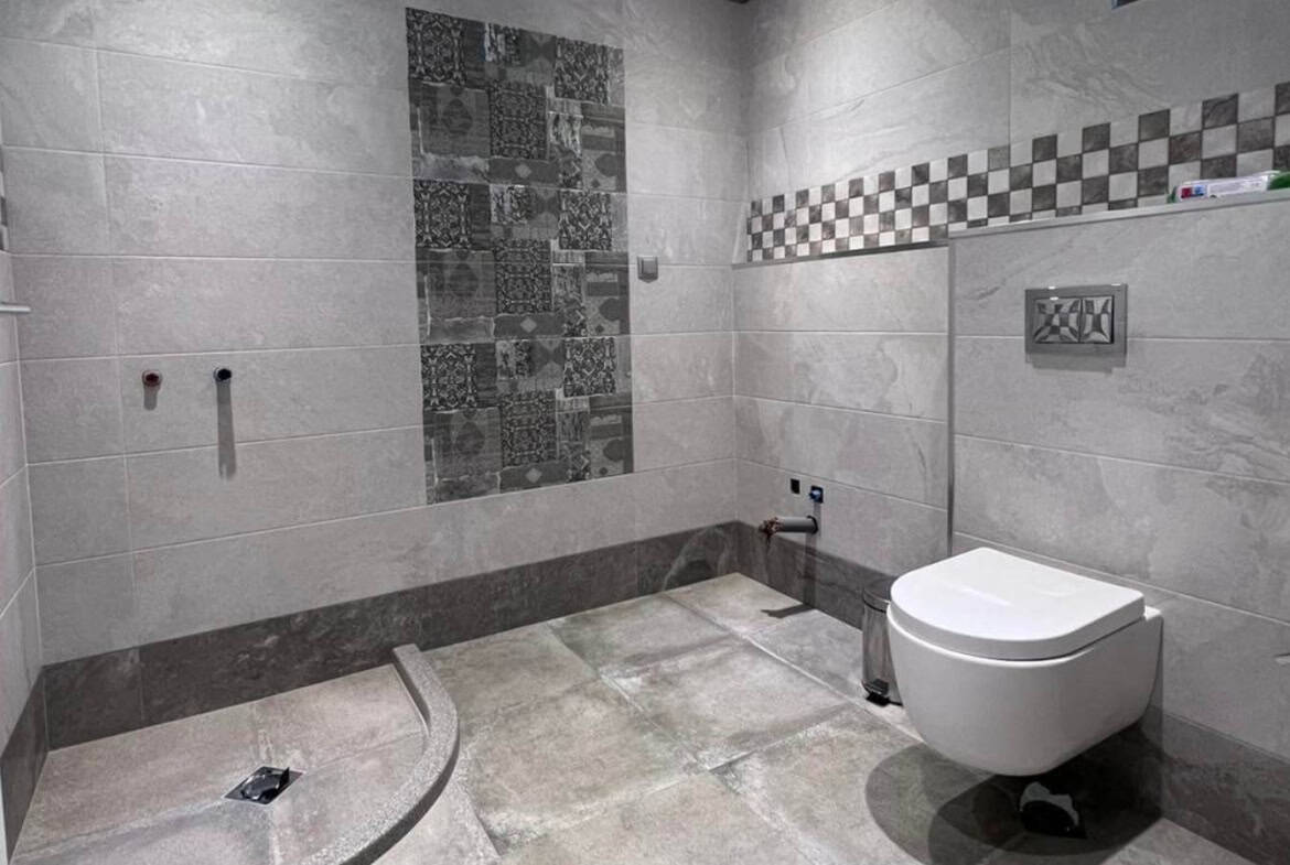 Unfinished bathroom with toilet seat