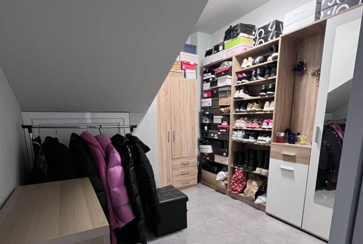 Shoe closet with a small wardrobe, hangers and mirror