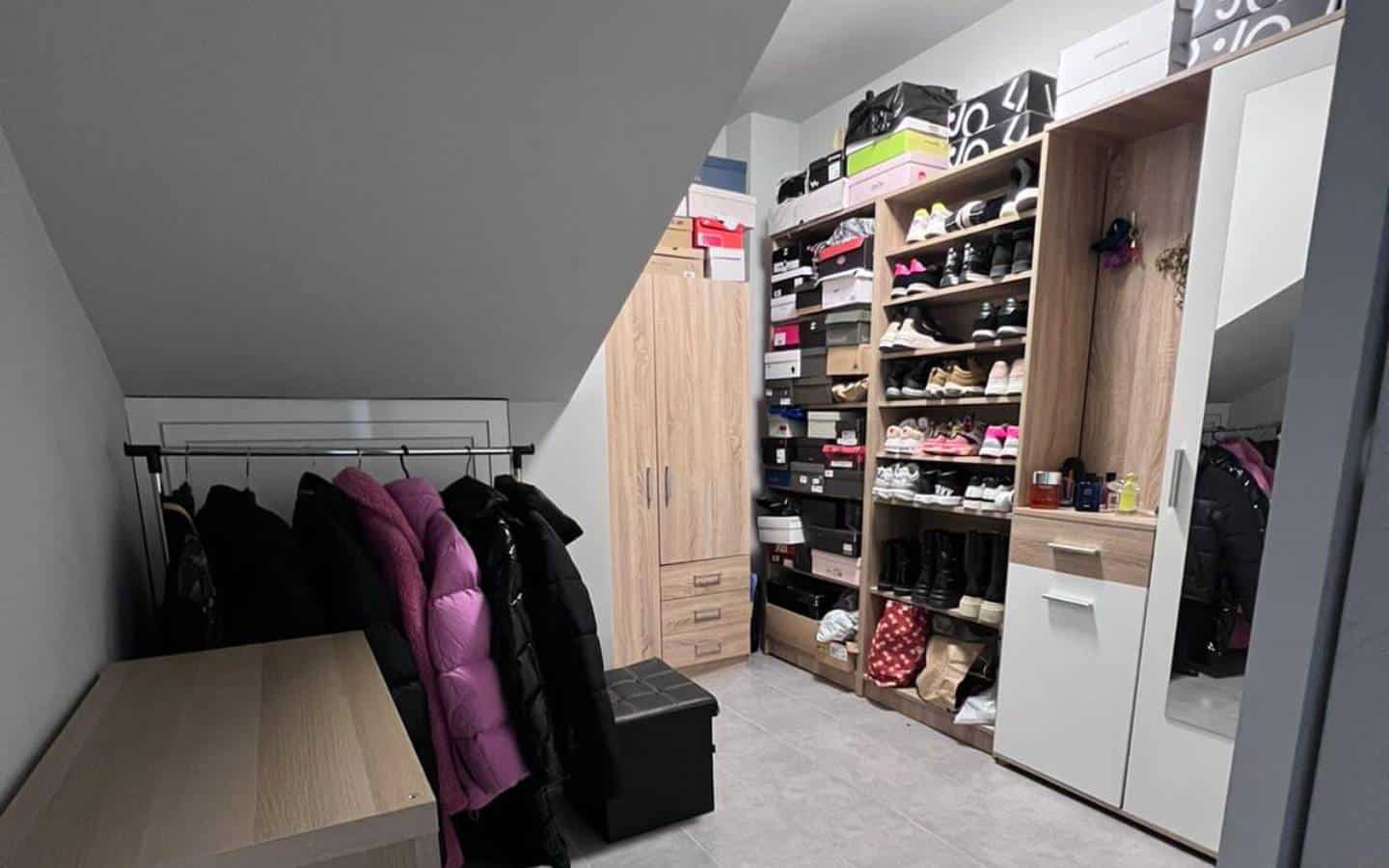 Shoe closet with a small wardrobe, hangers and mirror