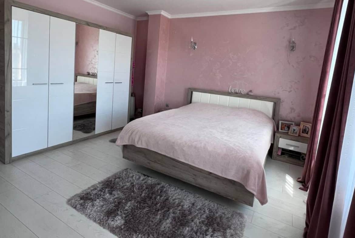 Pink bedroom with double sized bed and a four wing wardrobe