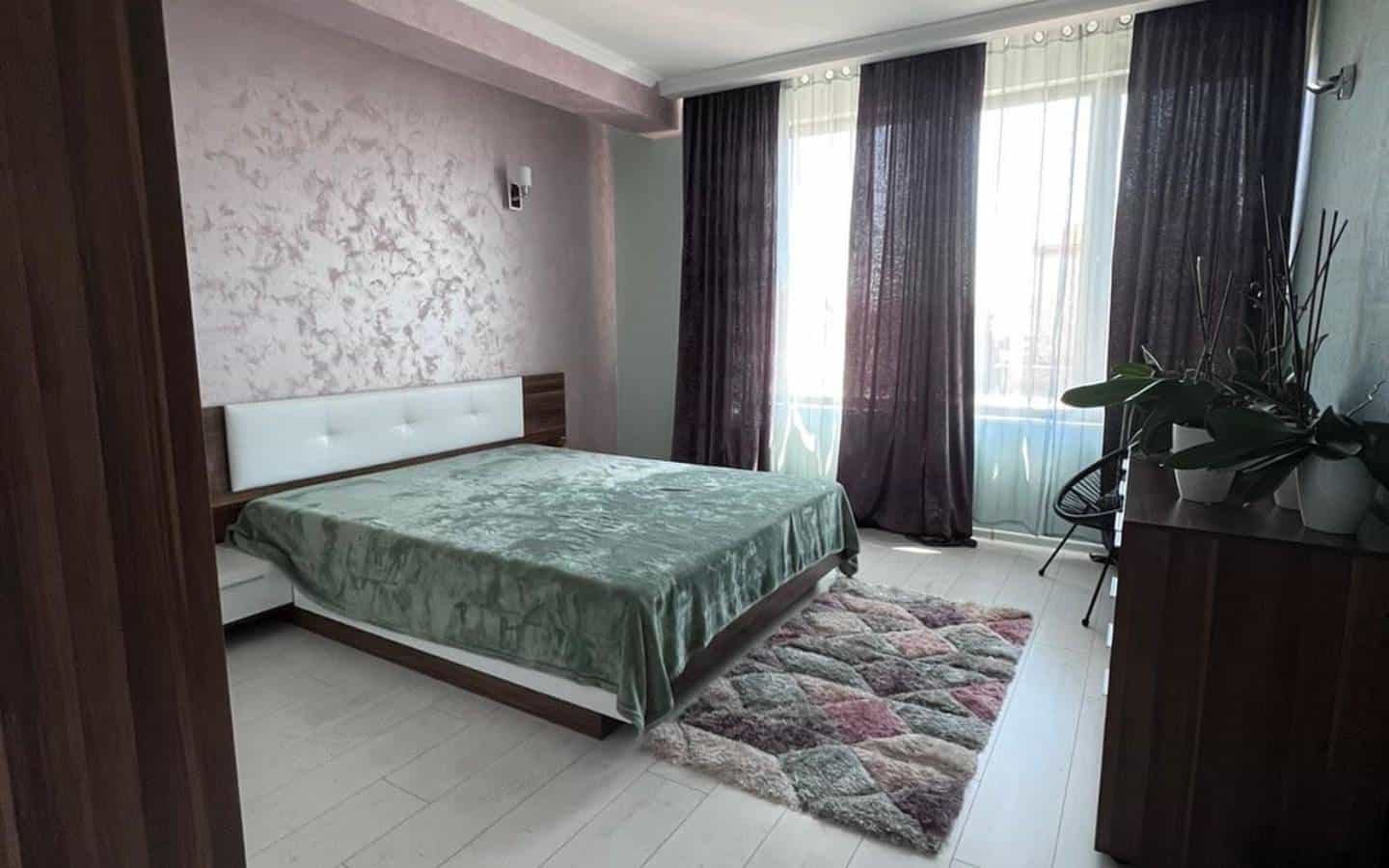 Purple bedroom with a double bed