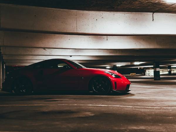 A red sport car in Bulgaria driving in a garage parking.