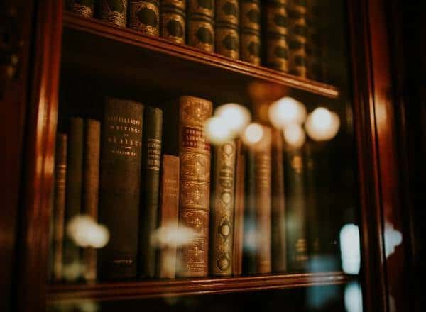 Old antique books behind a windowpane in a libray.