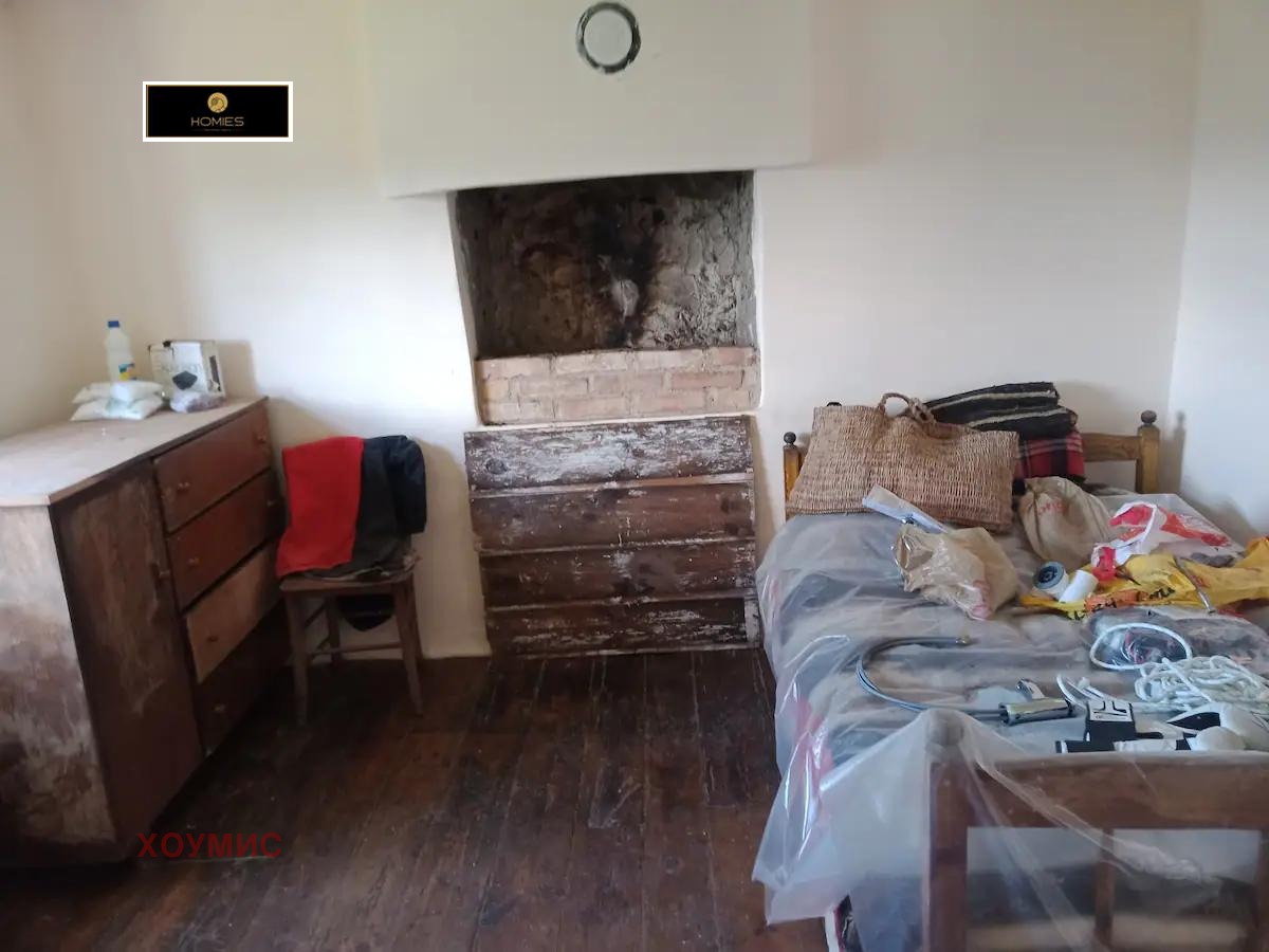 Bedroom with bed and fireplace in earthy tones