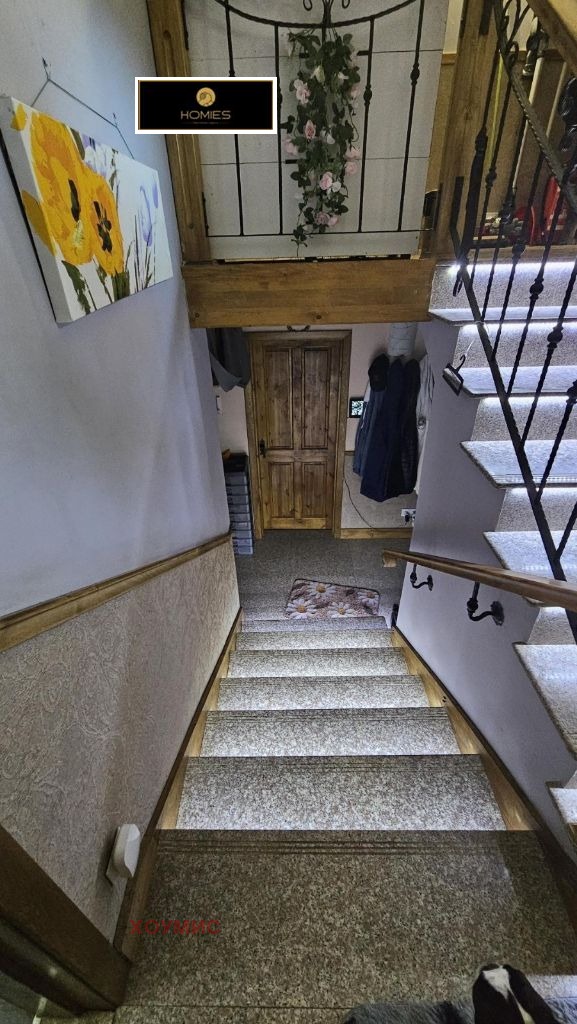 Narrow staircase with wooden door below