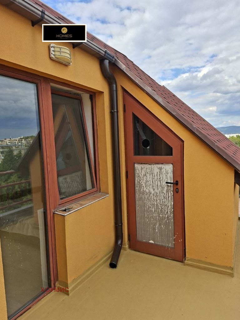 Yellow attic room with red door and window