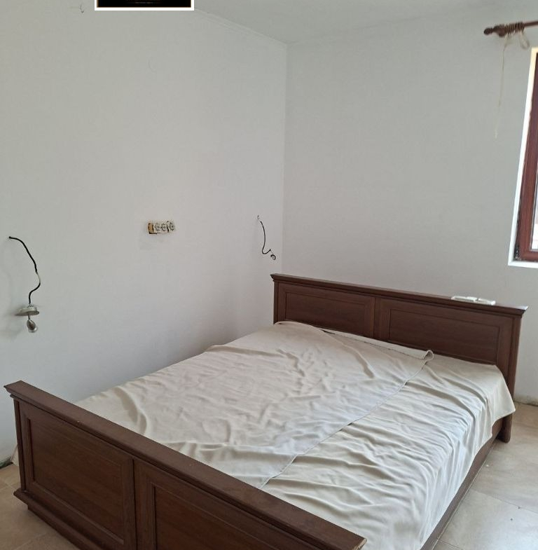 Minimalist bedroom with dark wooden bed frame