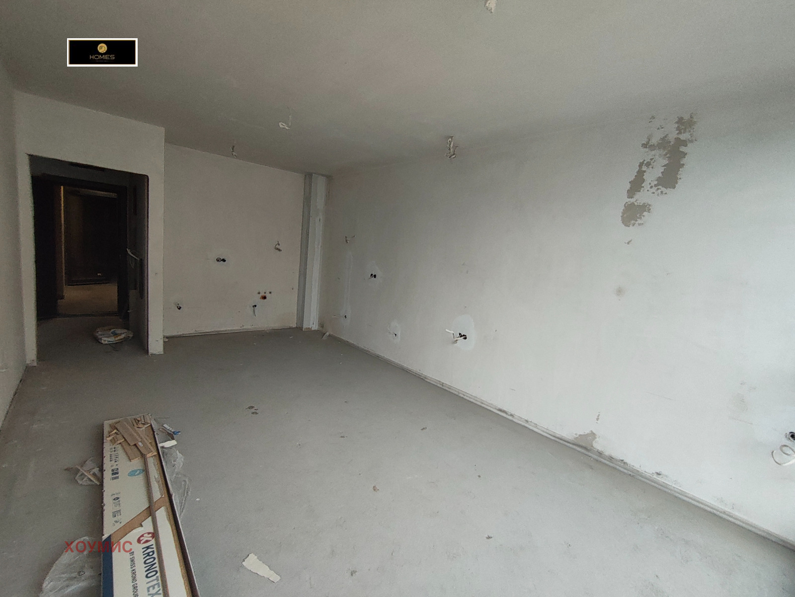 Spacious living room with white walls concrete floor