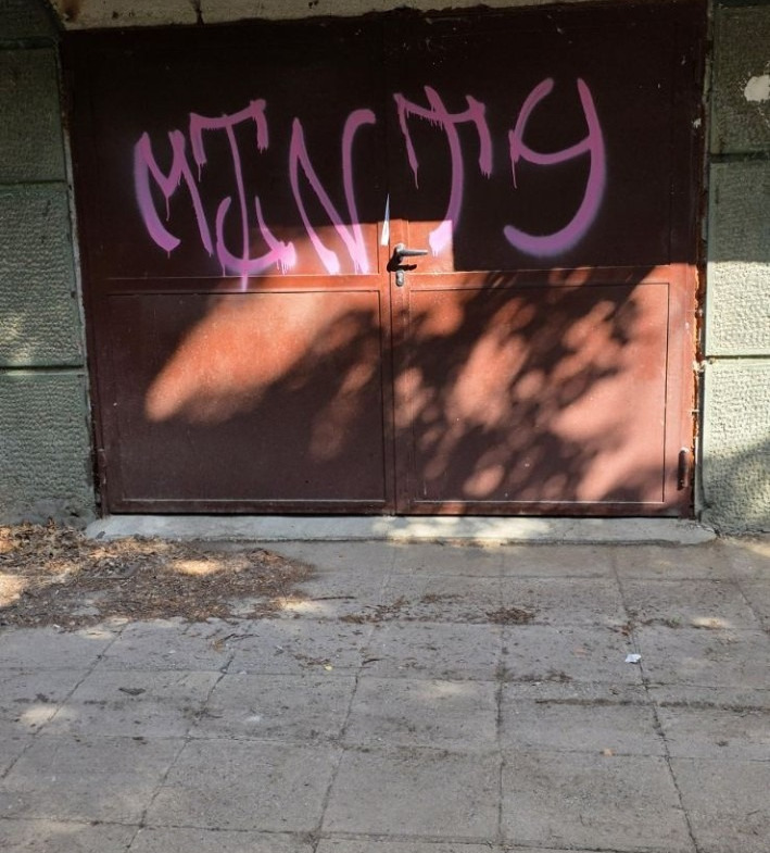 Garage with orange door and purple graffiti