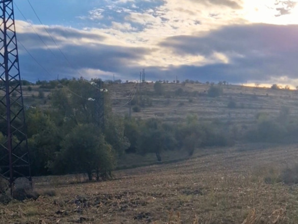 Agricultural land with panoramic valley view and sky