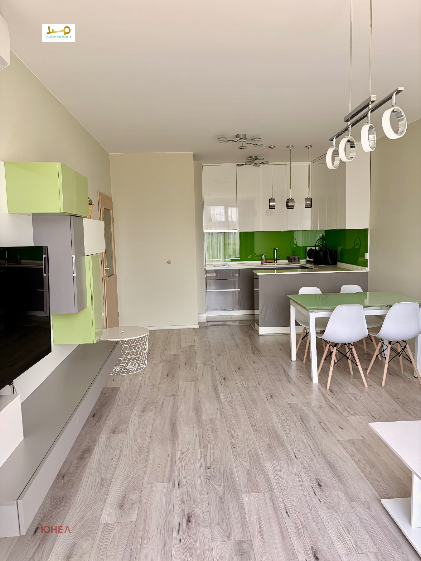 Modern kitchen with green backsplash and white cabinets