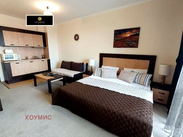 Modern studio apartment with bed and kitchenette