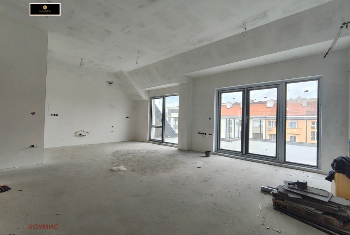 Spacious living room with bright windows and terrace
